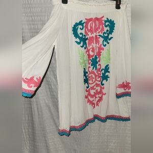 Gorgeous off the shoulder top with applique on front,sleeves and bottom.  Size L